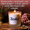Lit Zesty beeswax candle with wooden wick beside flowers and key
