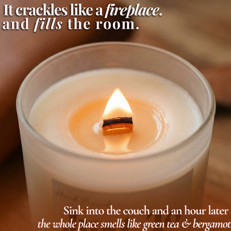 Lit beeswax candle with crackling wooden wick in frosted glass