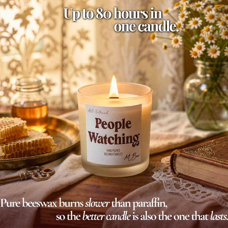 Lit People Watching beeswax candle with honeycomb and daisies