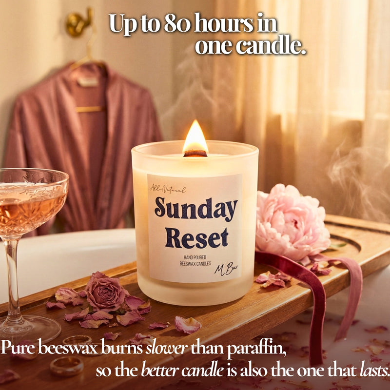 Lit Sunday Reset beeswax candle on bath tray with roses