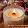 Lit beeswax candle with crackling wooden wick beside pink roses