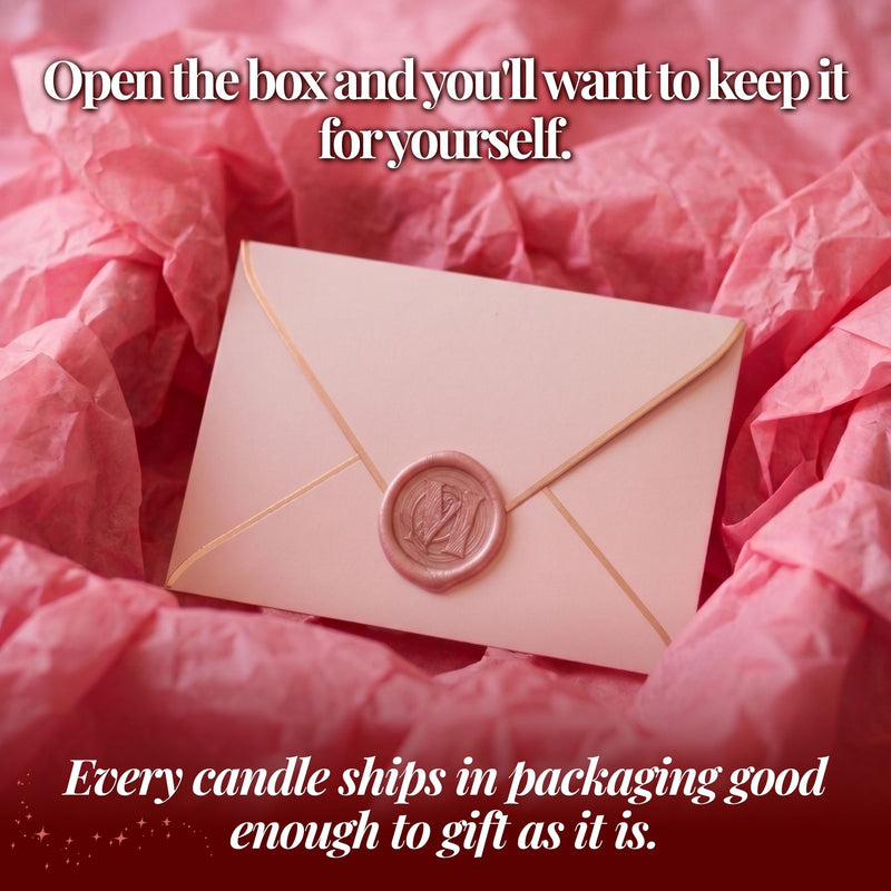 Pink wax-sealed envelope in tissue paper gift packaging