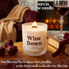 Lit Wine Down beeswax candle with wooden wick by fireplace and wine