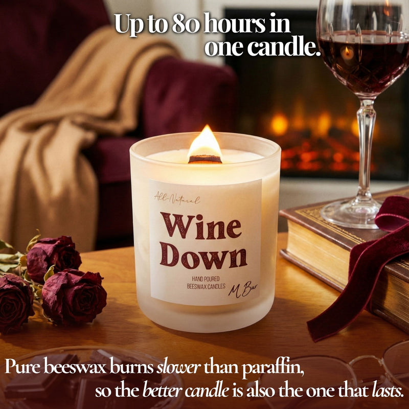 Lit Wine Down beeswax candle with wooden wick by fireplace and wine