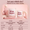 Wine Down candle size guide infographic with two pink candles