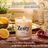 Lit Zesty beeswax candle with wooden wick beside fresh lemons