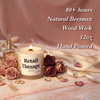 Lit Retail Therapy beeswax candle with wooden wick beside roses