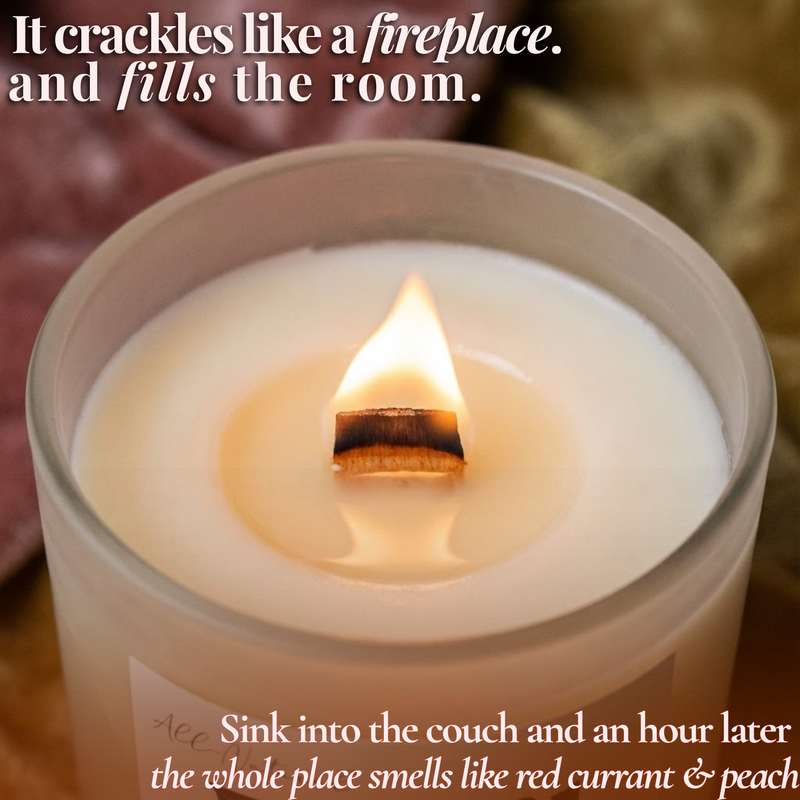 Lit beeswax candle with crackling wooden wick in frosted glass jar