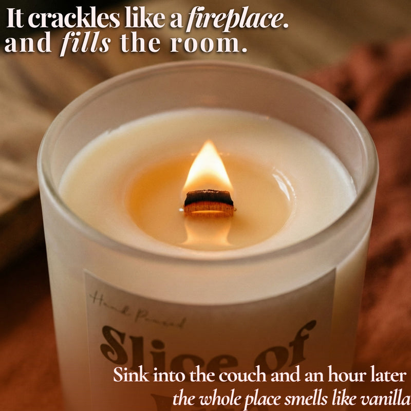 Lit beeswax candle with crackling wooden wick in frosted glass